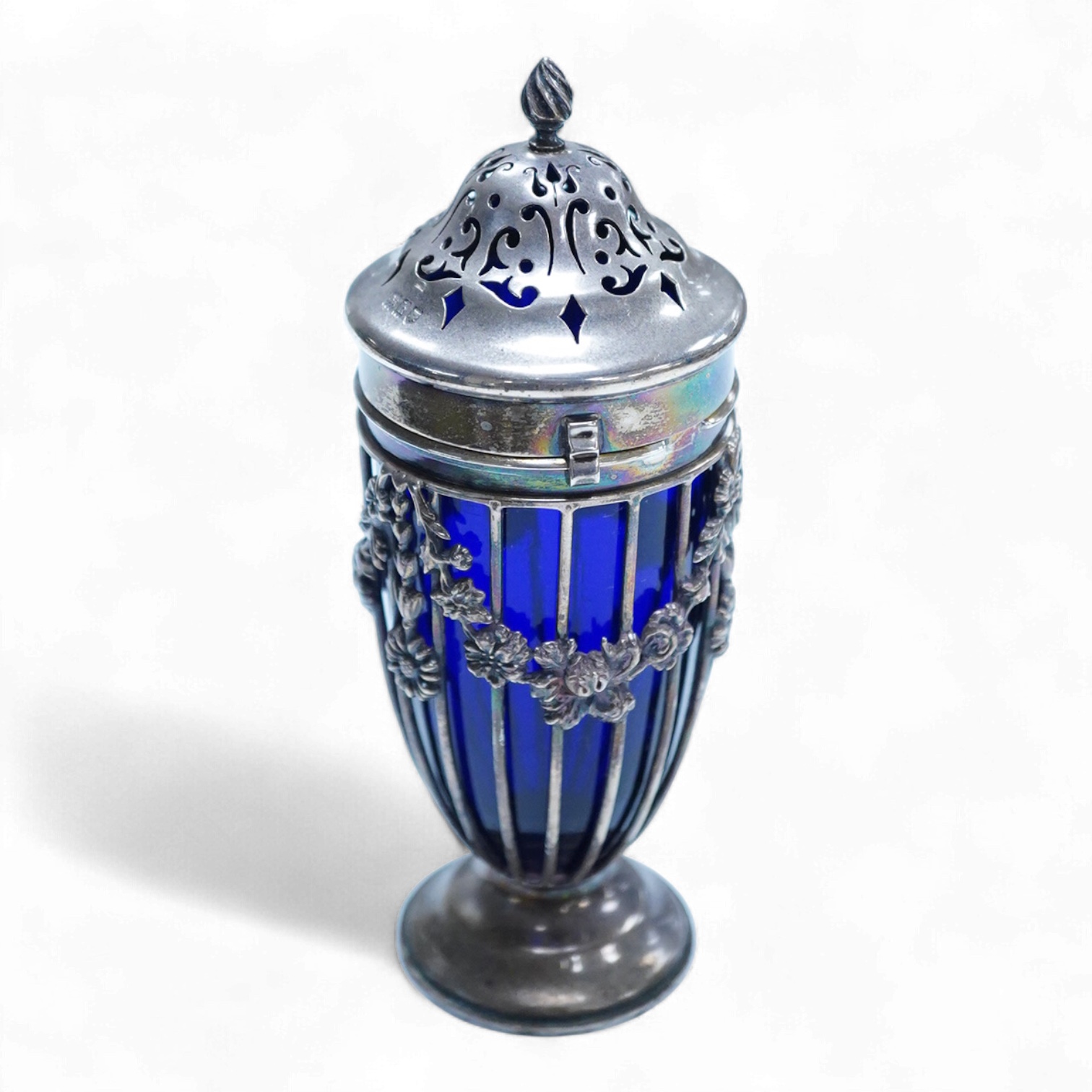 An Edwardian pierced silver sugar caster, with blue glass liner, Haseler Brothers, London, 1903, height 14.3cm.